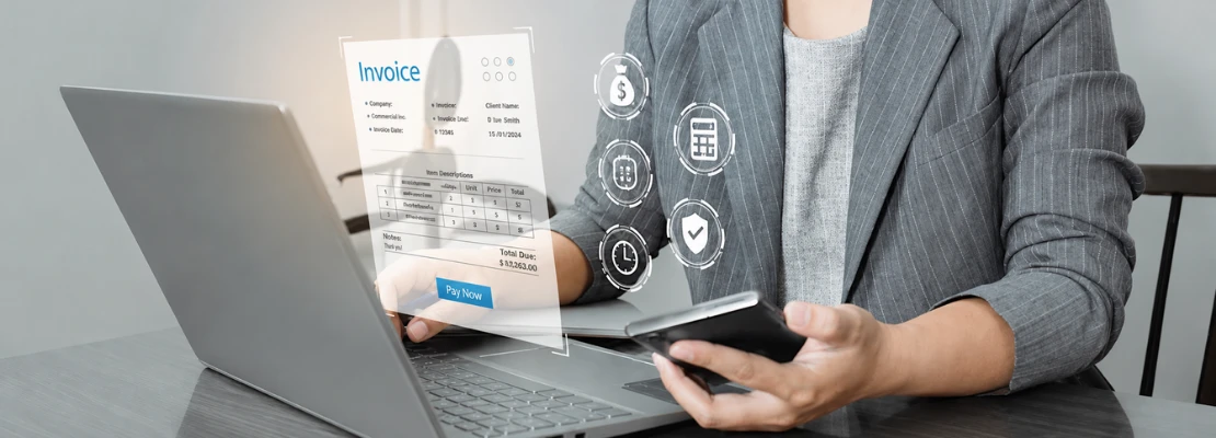 Professional managing digital invoices on a laptop and smartphone, showing how Odoo Malaysia helps businesses comply with the MyInvois e-invoicing mandate through a trusted Odoo partner Malaysia and Odoo service provider.