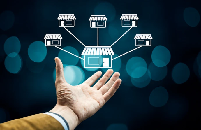 Hand holding connected store icons, representing Team C Creations’ Odoo implementation for 118 Subway franchise stores with centralized payroll, attendance, accounting, and multi-company management by an Odoo service provider.