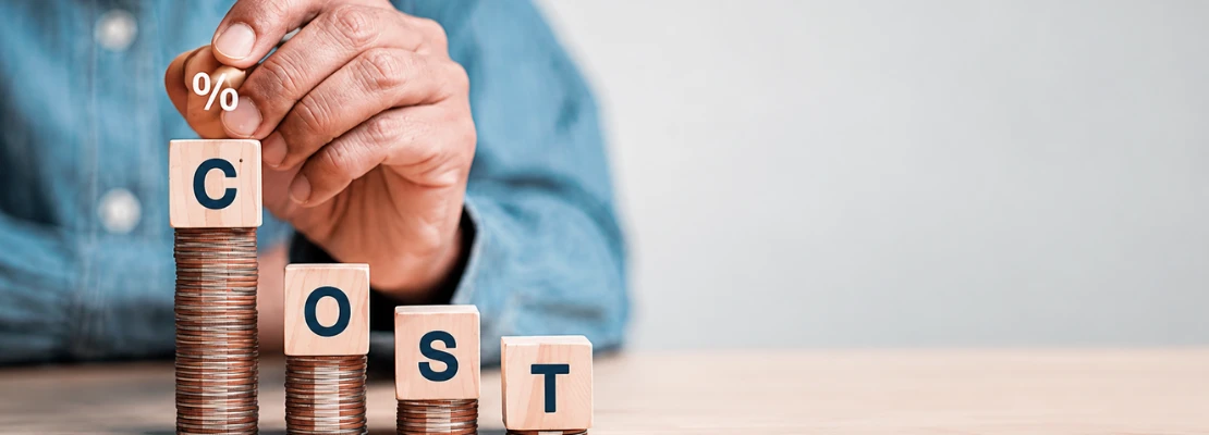 Coins stacked with blocks spelling cost, representing a clear Odoo Malaysia pricing estimate from a trusted Odoo partner Malaysia and Odoo service provider for business ERP needs.