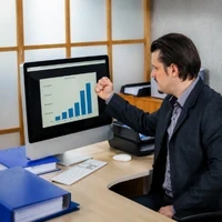 Business professional reviewing live reports and dashboard charts. Odoo customization services help improve real-time reporting visibility through custom ERP dashboards and analytics.