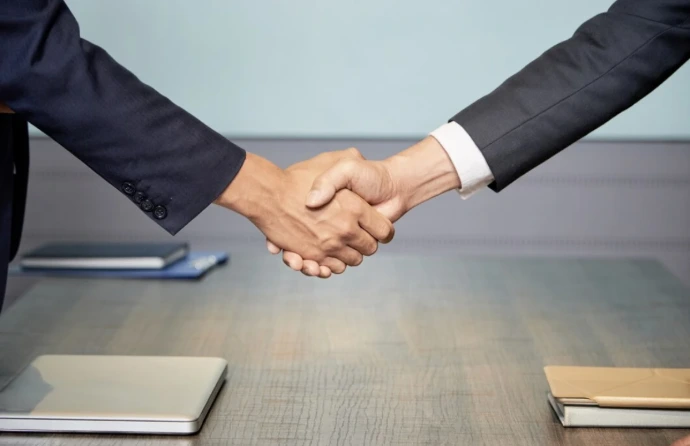 Long-Term Odoo Support and Maintenance Services Business partnership handshake showing long-term Odoo customization services and ERP support. Odoo ERP customization helps with maintenance, updates, and business growth.