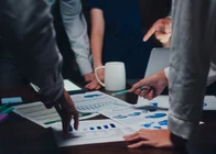Business team reviewing project charts representing Odoo implementation services and Odoo ERP implementation for project management.